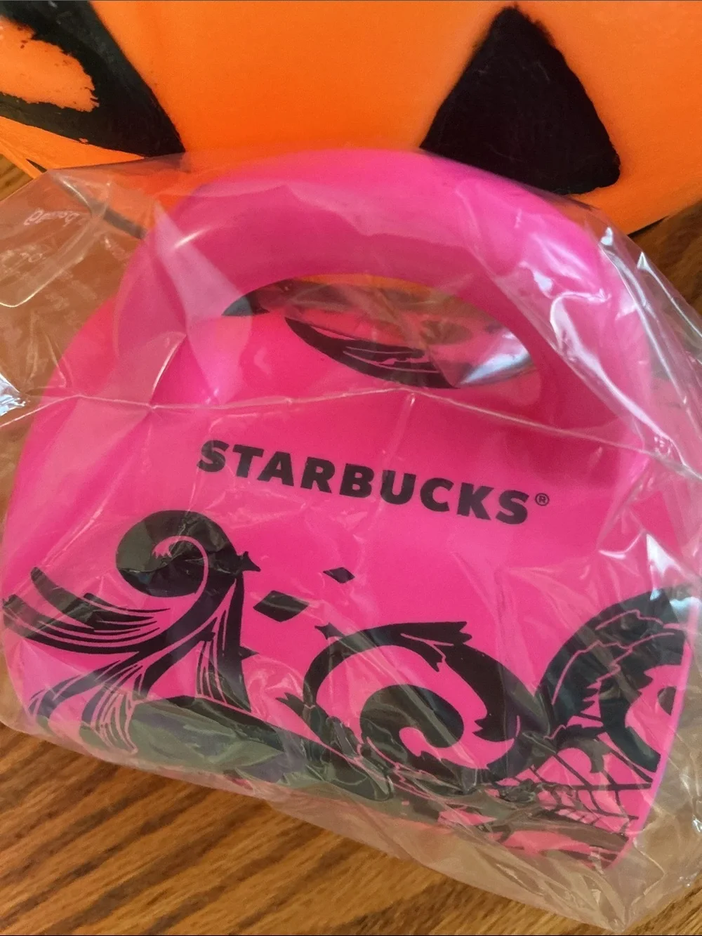 Starbucks Halloween 2021 neon pink coffee mug features a bold black cat-spider.